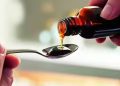 Cough syrup bottles displayed at a pharmacy as India introduces mandatory prescription requirements for syrup medicines.