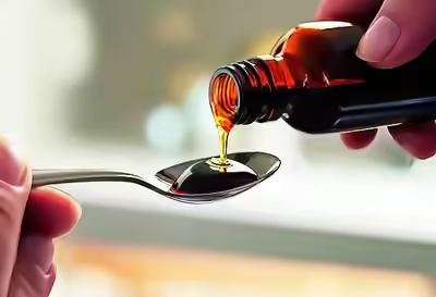 Cough syrup bottles displayed at a pharmacy as India introduces mandatory prescription requirements for syrup medicines.
